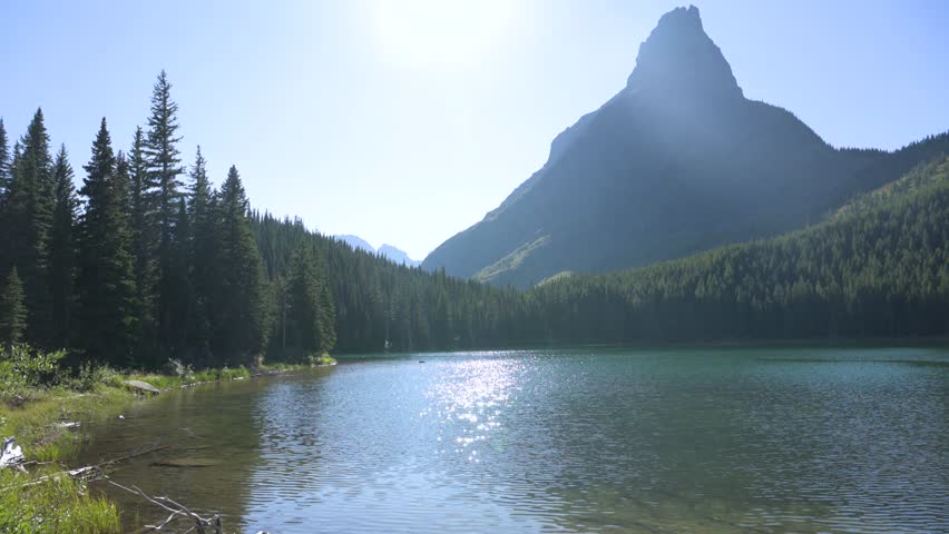 Grinnell Point in Glacier National Park viewed across lake, pan