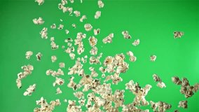 Popcorn flies up and falls down. On a green background. Filmed on a high-speed camera at 1000 fps. High quality FullHD footage - Powered by Shutterstock - Get 15% off with code: PIKWIZARD15