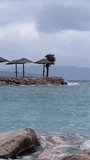 Beautiful cinematic water splashes. Powerful waves crashing the coast of Njivice, Croatia one day after Storm Ciarán smashed into Krk Island. Birds flying above the disquiet sea surface.