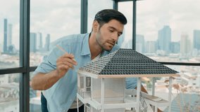 Professional architect engineer using pencil measuring model roof length at modern office with skyscraper, cityscape view. Skilled project manager or businessman check house construction. Tracery - Powered by Shutterstock - Get 15% off with code: PIKWIZARD15
