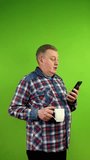 Senior man in casual clothing talking with phone webcam about things at life.