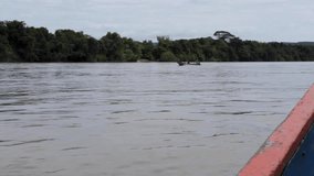 Slow motion video of a boat sailing along the rio guayabero in la macarena, meta, colombia