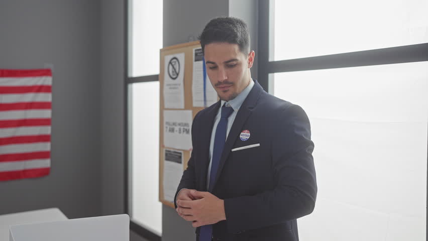 Handsome hispanic man with a beard, wearing a suit, pointing at his 