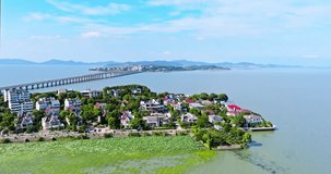 Aerial video of Taihu Villages and lake with mountain natural landscape in Suzhou. Famous tourist destinations in Suzhou. Drone surround shooting.
