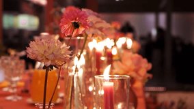 Pink flowers against the backdrop of burning candles in glass containers - Powered by Shutterstock - Get 15% off with code: PIKWIZARD15