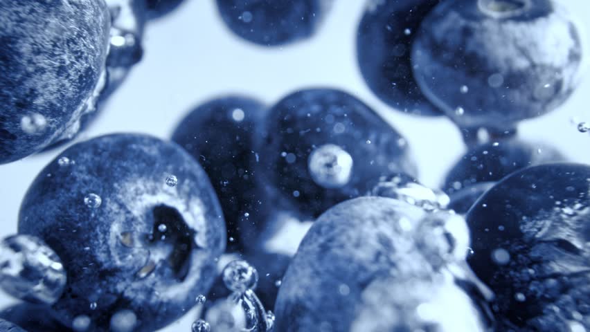 Super Slow Motion Shot of Fresh Blueberries Falling into Water and Creating Bubbles at 1000fps.