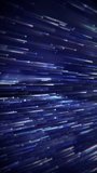 Vertical video - a stream of flowing blue digital fiber optic light data node particles. Communication and connectivity concept. Full HD and looping technology motion background animation.