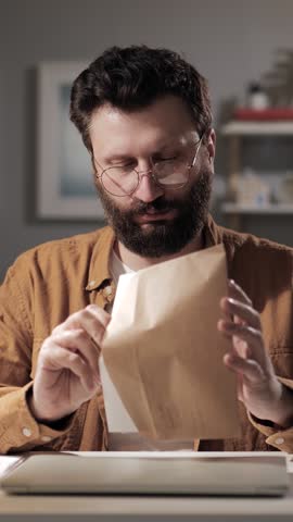 Lawsuit, complaint, claim concept. Man with mysterious face puts document in envelope. Close-up of dissatisfied customer threatening to sue Royalty-Free Stock Footage #3468225289
