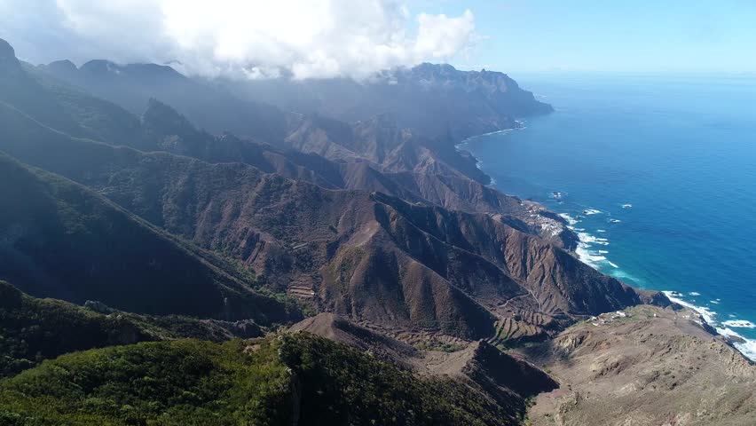 Flight over beautiful mountains near ocean shore