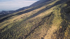 Aerial view of Mount Etna, Sicily. Cinematic drone shot of volcanic landscape in famous travel destination of Italy. Drone shot travelling forward at low altitude