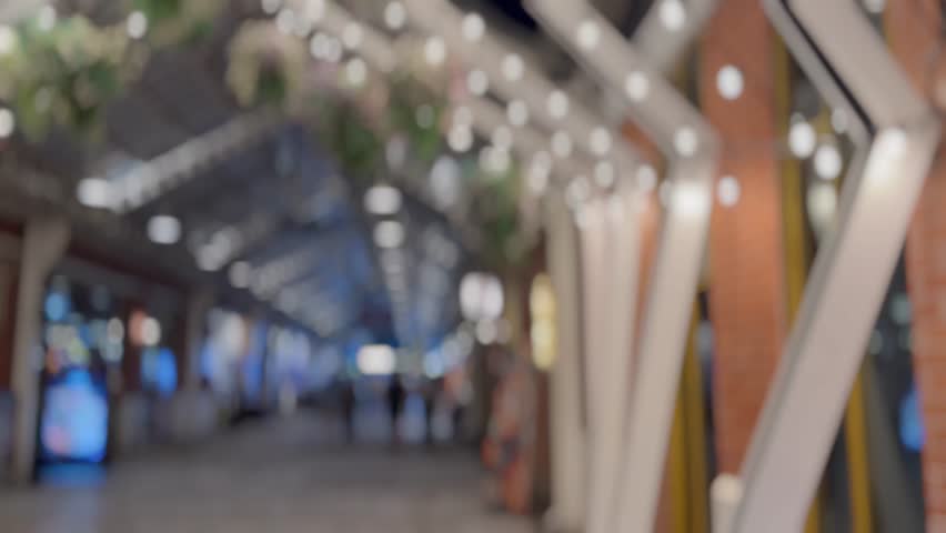 Blurred background of a night market walkway.