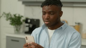 Stressed African American ethnic man shocked mobile phone bad news at home reading trouble notification problem lost failure smartphone confused guy male cellphone annoyed stress error sms complaint - Powered by Shutterstock - Get 15% off with code: PIKWIZARD15