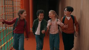 Group of happy talking multiethnic diversity pupils diverse children talk walking in school corridor kids classmates go walk in hall come in classroom learning studying friendship talking laughing - Powered by Shutterstock - Get 15% off with code: PIKWIZARD15