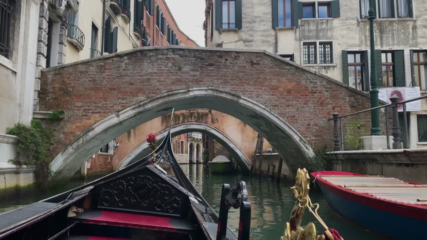 A ride in a gondola under the small bridges in Venice