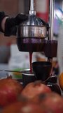 squeezes pomegranate juice vertical video