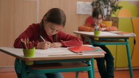 Caucasian little schoolgirl writing school class lesson rise hand answer question teacher clever smart child kid girl answering tutor boy rising arm children classmates elementary education studying - Powered by Shutterstock - Get 15% off with code: PIKWIZARD15