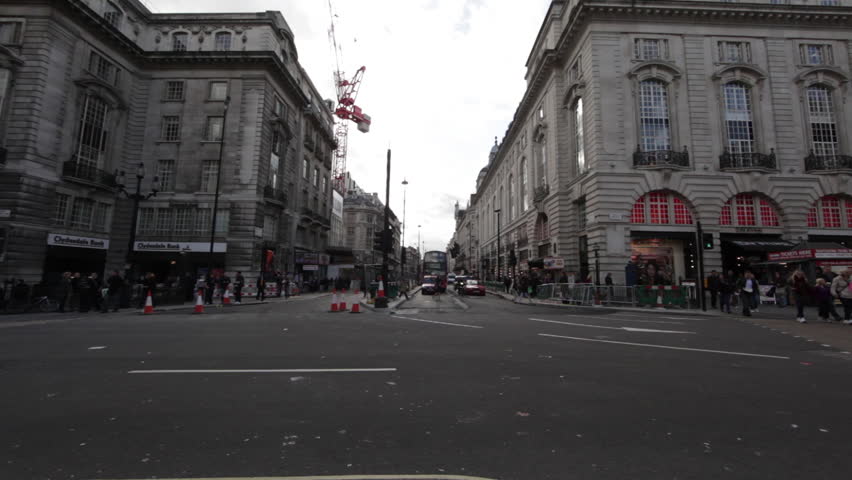 LONDON - OCTOBER 7, 2011: A busy street in London with crowds of people, old