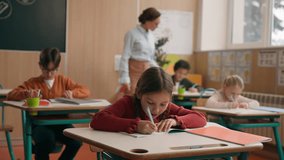 Female teacher woman tutor at school class lesson teach children walking classroom elementary primary education learning kids boys girls teaching diversity schoolchildren help with study check tasks - Powered by Shutterstock - Get 15% off with code: PIKWIZARD15