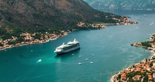 Amazing hyperlapse video of the picturesque bay of Kotor bay with old town, with beautiful coastline and cruise ship entering the port, yachts and boats ply the bay