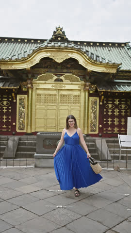 Beautiful hispanic woman with glasses spinning joyfully in her dress around ueno park temple, tokyo. her vibrant spirit dances amidst the urban setting, capturing japan