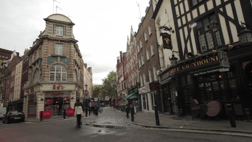 LONDON - OCTOBER 7, 2011: A corner street with a little diner near Soho Square