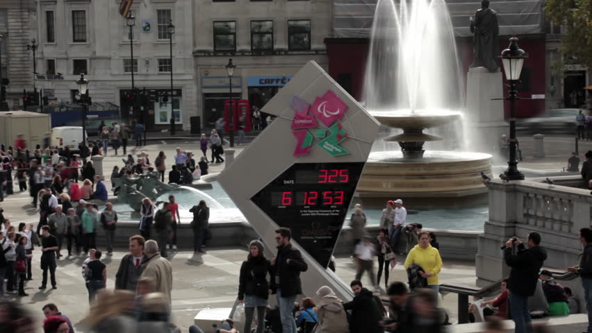 LONDON - OCTOBER 9, 2011: Olympic countdown sign and people walking about
