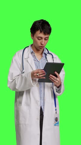 Front view Medic specialist buying something online on web store using credit card, woman ordering on internet and paying with electronic e commerce transaction. Doctor purchasing things on tablet