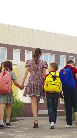 kid child mother go to school with backpacks holding mom hand, happy family, smile face, girl boy child kid, brother sister duo accompanying mom school, mother leads child school holding hand, sister Royalty-Free Stock Footage #3468590757