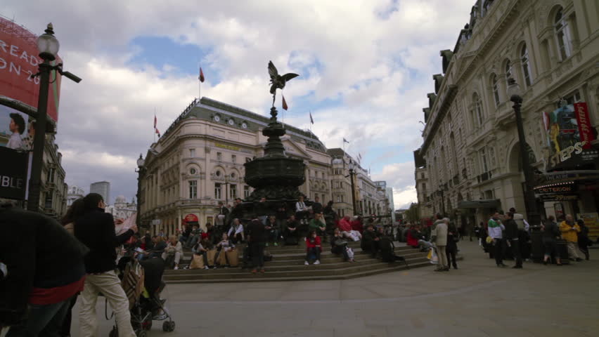 LONDON - OCTOBER 7, 2011: People standing and sitting around the Eros statue in