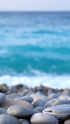 Zen meditation background - building balanced stones stack cairn close up on sea beach