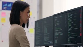 Concentrated Asian female developer debugging software on a multi-monitor setup, engaged in complex problem-solving. - Powered by Shutterstock - Get 15% off with code: PIKWIZARD15