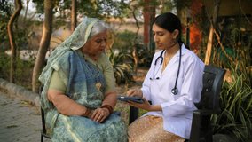 Female doctor explaining the latest medical reports of an old lady - full body checkup, doctor's advice. Grey-haired Indian villager listening patiently to her doctor - health and wellness, rural h... - Powered by Shutterstock - Get 15% off with code: PIKWIZARD15