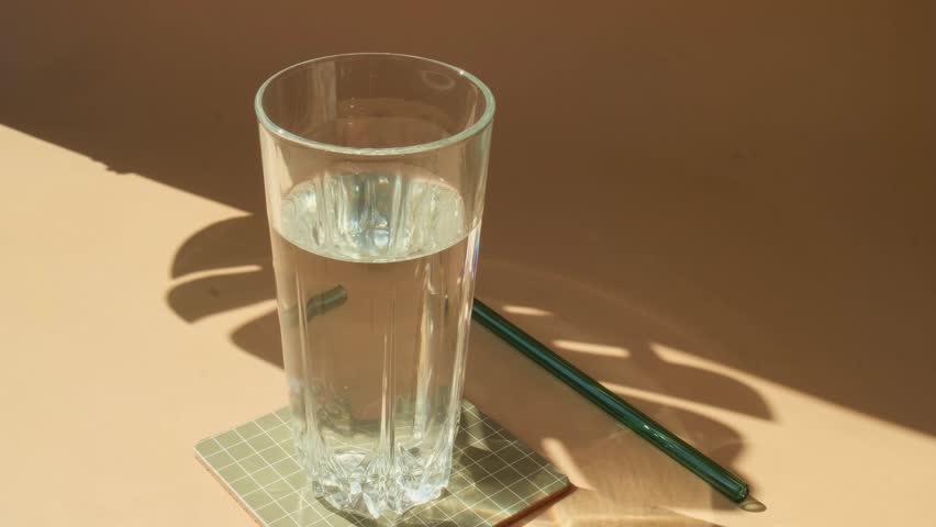 Pouring Organic blue-green algae spirulina detox drink in glass powder food. Health protein cocktail smoothie of chlorella. Vitamins and minerals to diet. Prebiotic and antioxidant rich Dietary