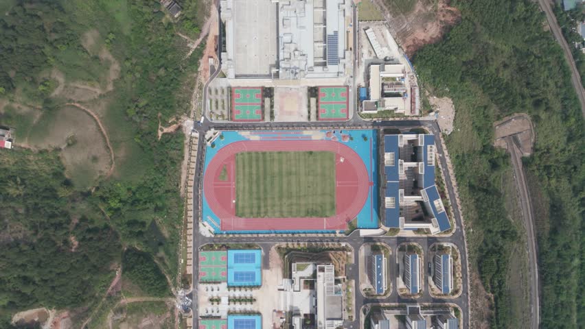 new primary and secondary school, sports complex, residential complex, sports ground, China. Top view of the new stadium. Open stadium. Chinese sports infrastructure