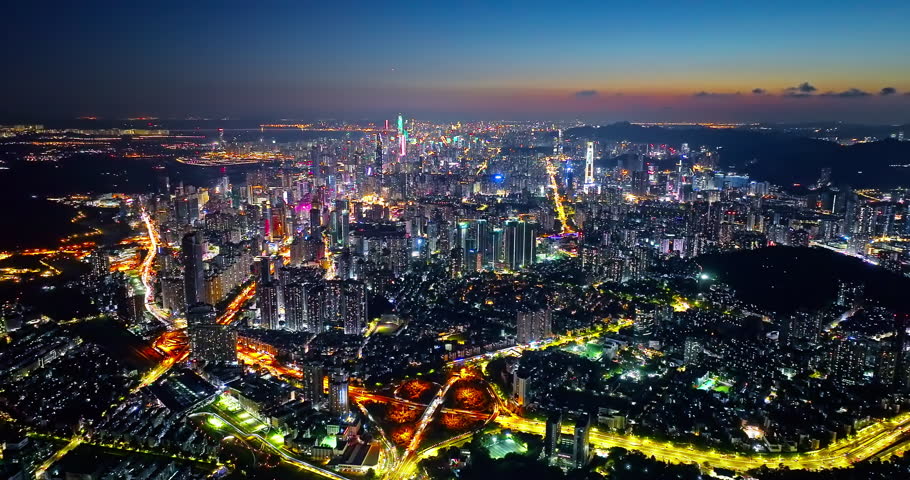 Aerial panning shot of Shenzhen modern city skyline panorama at evening