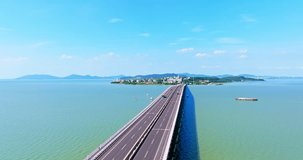 Aerial video of highway road and lake with mountains natural landscape in Taihu, Suzhou. Drone forward shooting.