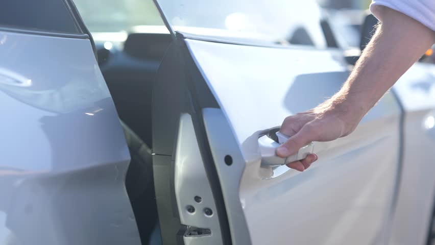 Close up of human male hand opening door of white car. Passenger seat. Transport and lifestyle concept. Slow motion