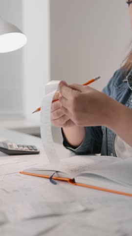 An entrepreneurial woman is engaged in cost accounting and financial stability analysis in her home work area. Her energy and focus make her an excellent family budget manager. Price increase