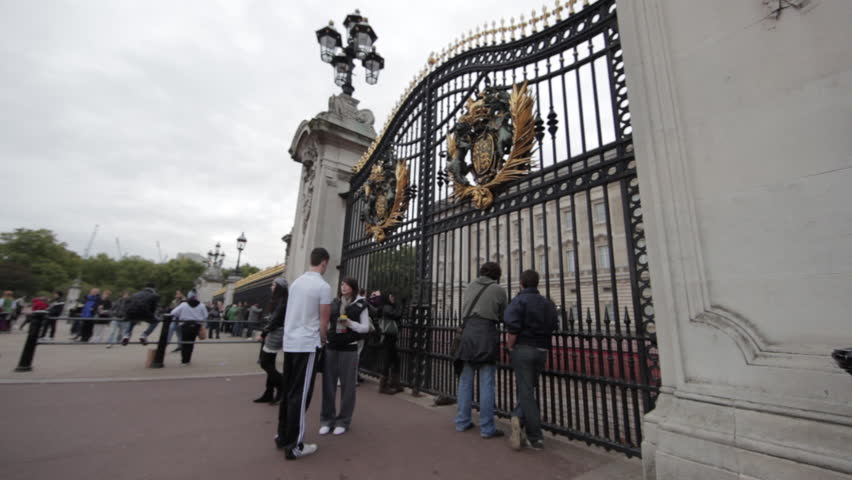 LONDON - OCTOBER 9, 2011: Unidentified people stand outside the gates at