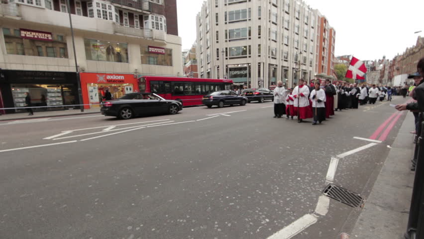 LONDON - OCTOBER 9, 2011: Parade of christian priests walk down the street 