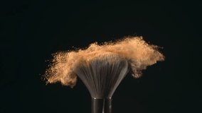 Super slow motion macro shot of makeup brush and golden shiny face powder shake at 1000 fps. Elegant luxury make up cosmetic abstract background. Beauty make-up glitter flying in high speed close up - Powered by Shutterstock - Get 15% off with code: PIKWIZARD15