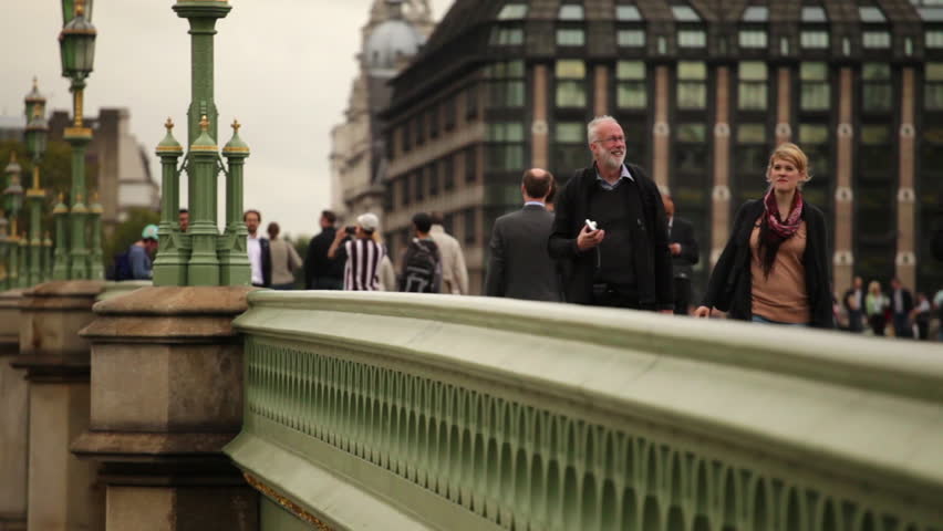 LONDON - OCTOBER 11, 2011: Unidentified people walk across Westminster bridge 