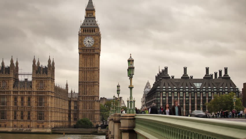 LONDON - OCTOBER 11, 2011: Unidentified people cross bridge with Westminster