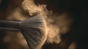 Makeup brush and golden face powder shake at 1000 fps. Elegant luxury make up cosmetic macro abstract background in super slow motion. Beauty make-up glitter flying. High speed close up vertical video - Powered by Shutterstock - Get 15% off with code: PIKWIZARD15