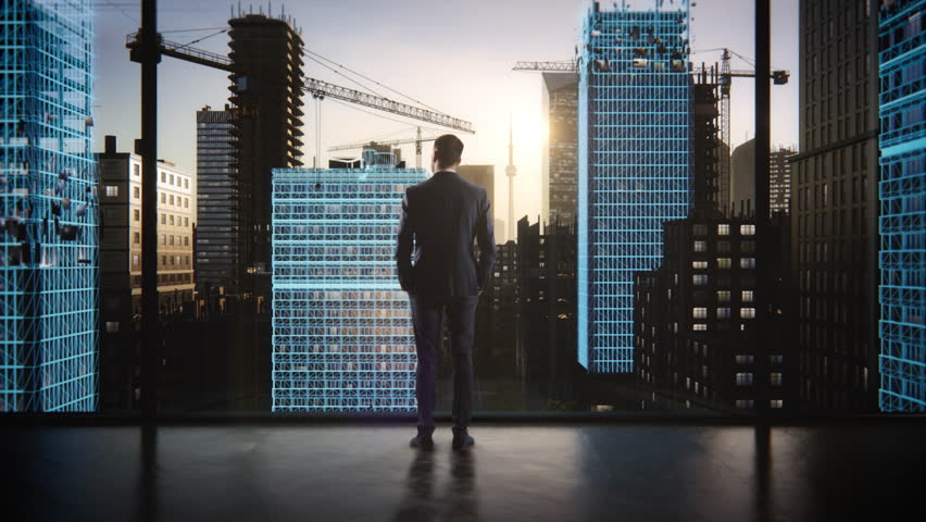 Backview Of Caucasian Businessman Standing In Skyscraper Office And Looking Out Of The Window. Successful Real Estate Entrepreneur Watching Sunset and VFX Visualization Of Office Buildings Being Built