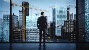 Backview Of Caucasian Businessman Standing In Skyscraper Office And Looking Out Of The Window. Professional Real Estate Investor Watching 3D Visualization Of Office Buildings, Appartments Being Built. - Powered by Shutterstock - Get 15% off with code: PIKWIZARD15