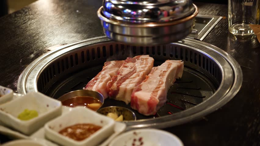 Typical korean bbq grill. Korean barbecue cooked and served at a restuarant in Seoul, South Korea. High quality 4k footage
