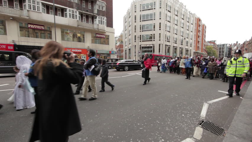 LONDON - OCTOBER 8, 2011: Unidentified people walking down the street in a