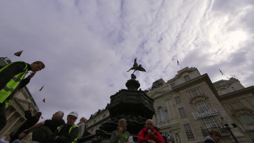 LONDON - OCTOBER 7, 2011: Unidentified people eat lunch on the steps of Eros