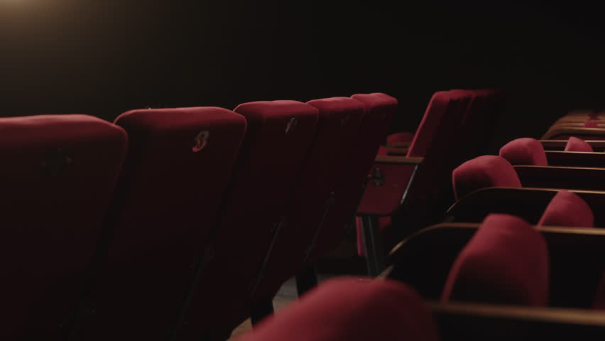 No people shot of empty red theatre seats in low light Royalty-Free Stock Footage #3468970685